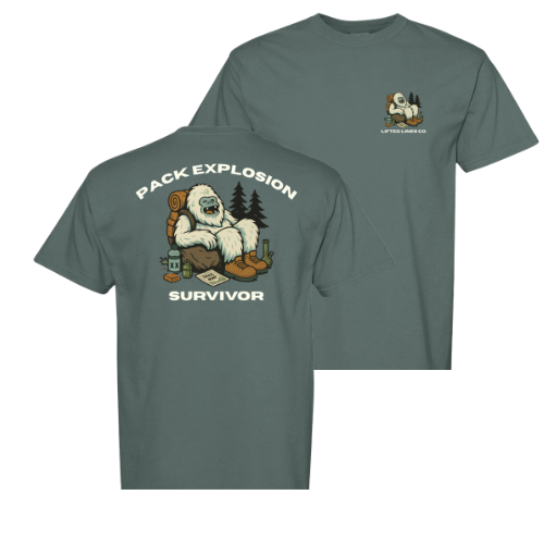 Gray t-shirt with a graphic of a bear and text 'Pack Explosion Survivor' on the front, and a logo on the sleeve.