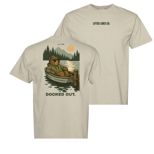 Beige t-shirt with bear in a boat graphic and 'Docked Out' text on a white background
