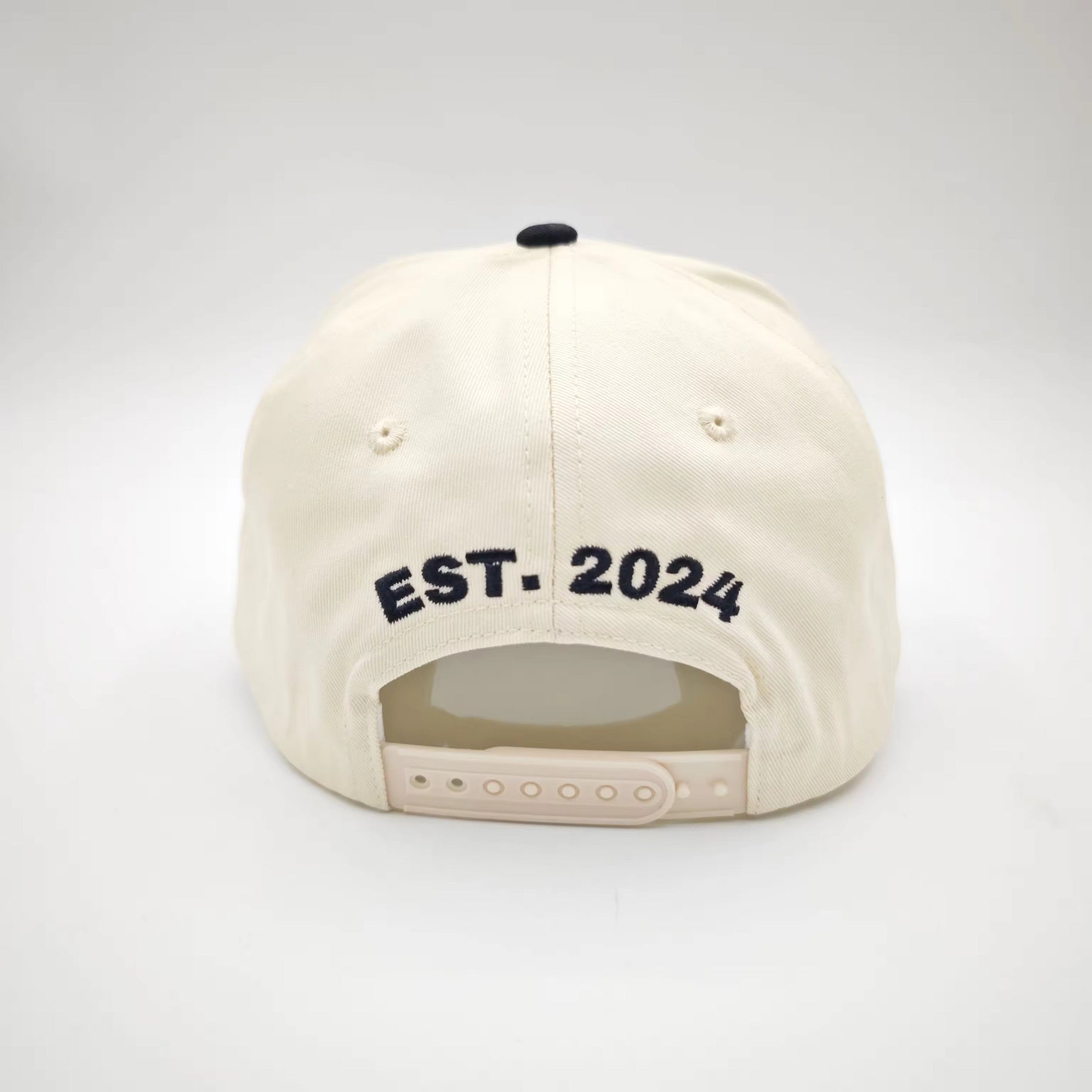 Beige cap with 'EST. 2024' text on a white background