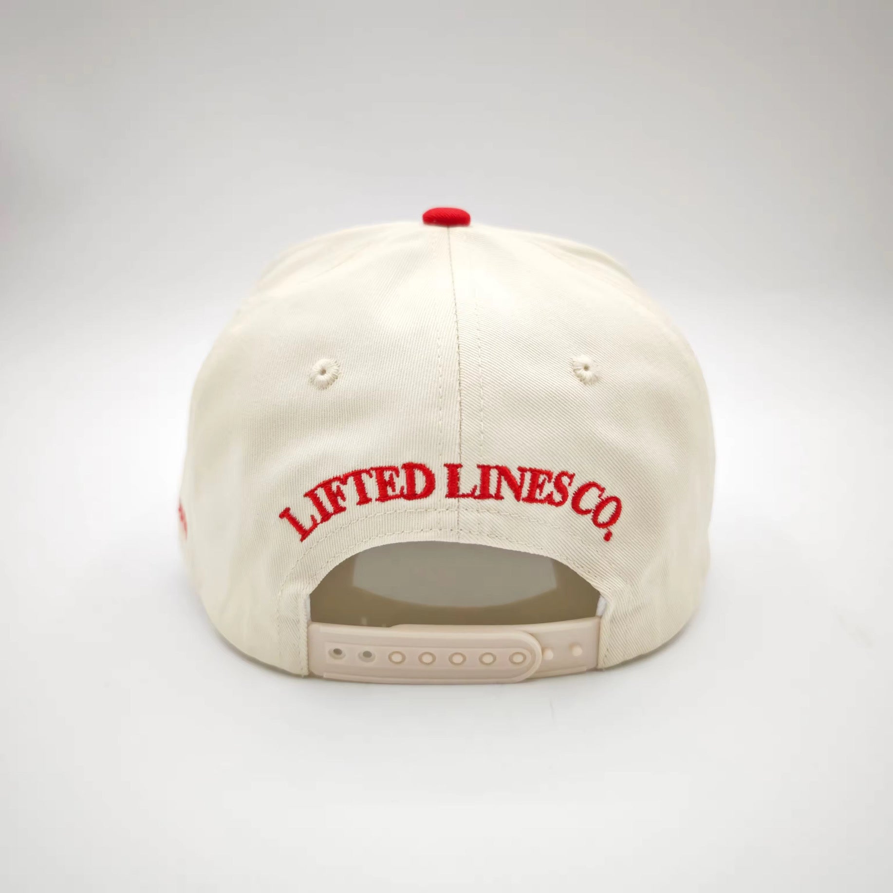 Beige cap with red 'Lifted Lines Co.' logo on a white background