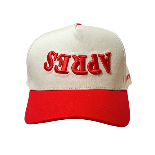Beige and red cap with 'APRS' text on a white background