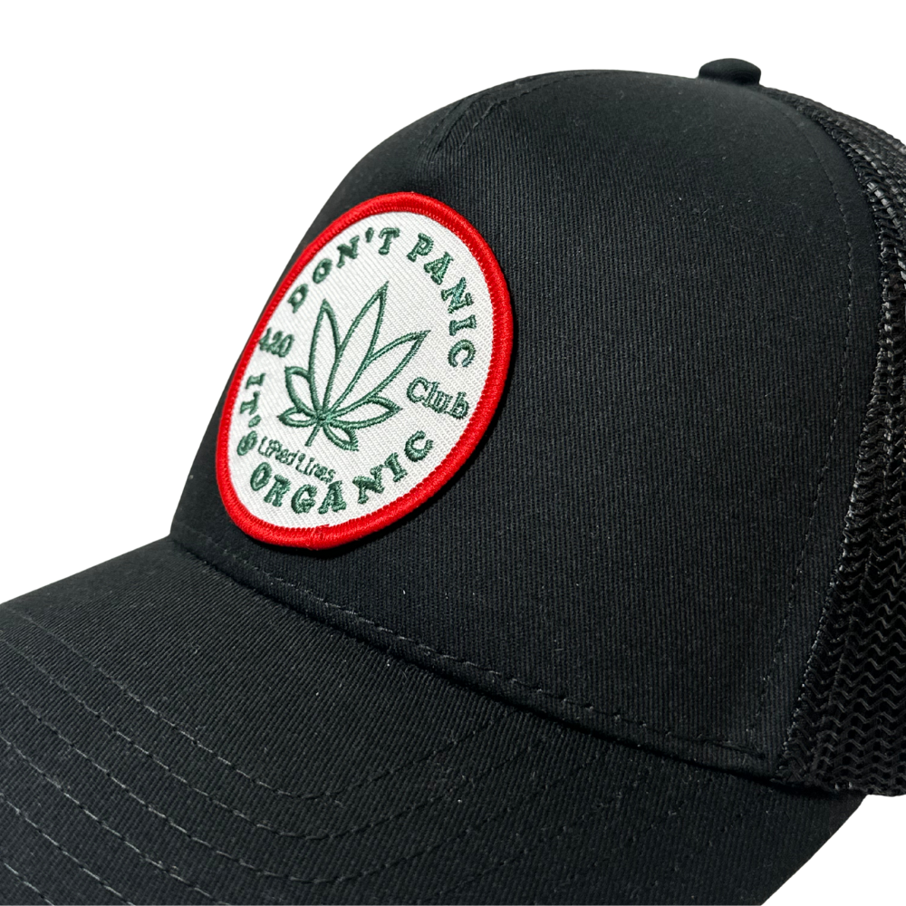 Black cap with a marijuana leaf patch on a white background